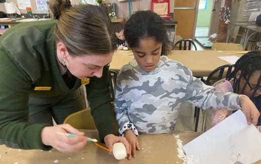 a person and a child sitting at a table