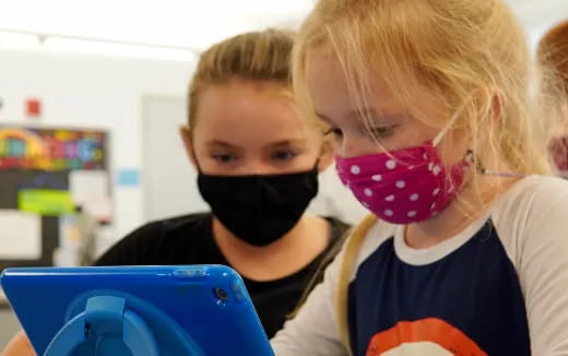 a couple of children wearing masks