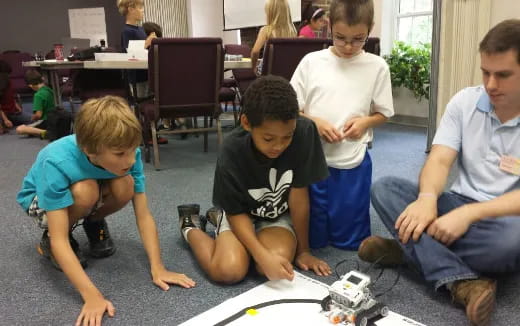 a group of kids playing with a toy train