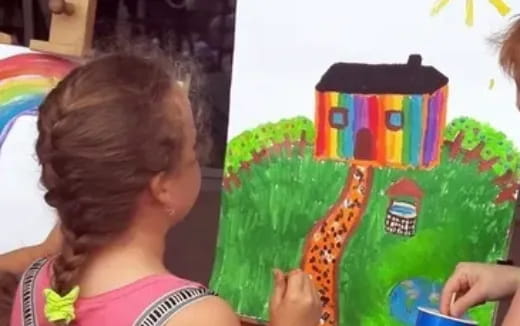 a girl holding a green and yellow gift box