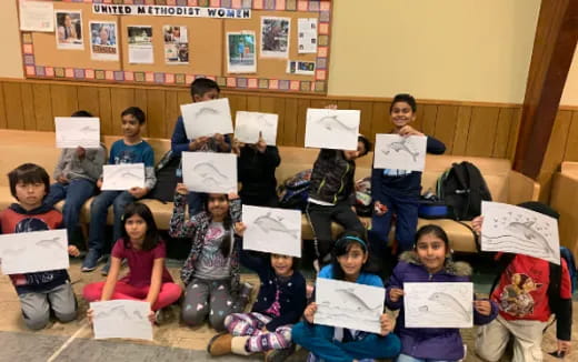 a group of children holding papers