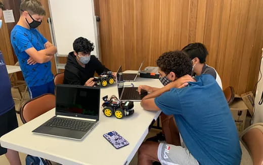 a group of people working on laptops