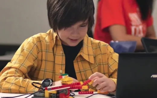a young boy playing with a toy