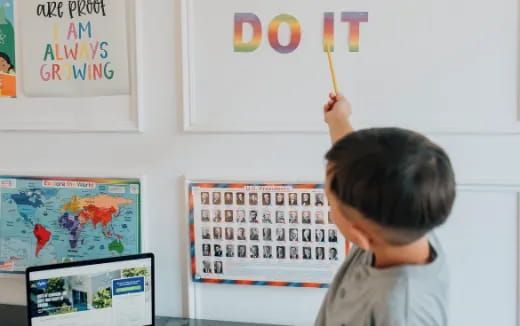 a child drawing on a white board