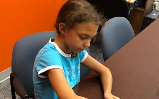 a child sitting at a table