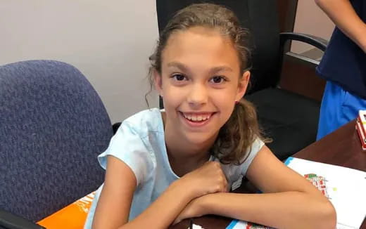 a girl smiling at the camera