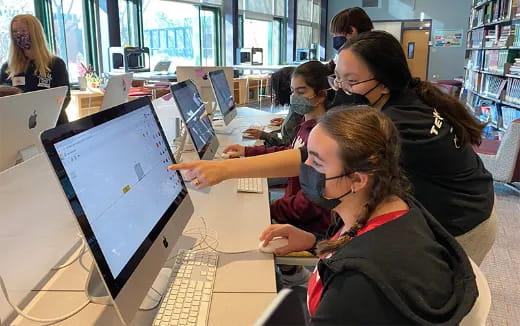 a group of people working on computers