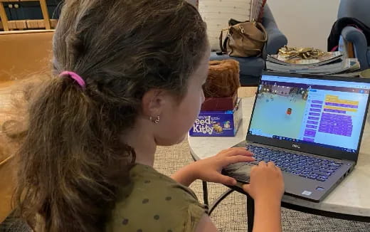 a young girl using a laptop