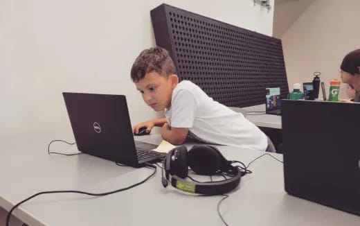 a boy using a laptop