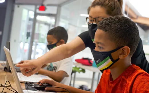 a group of boys using a computer