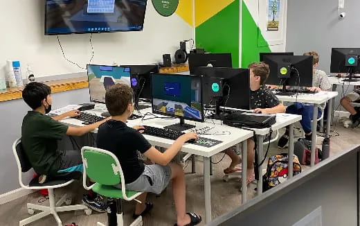 a group of people sitting at computers