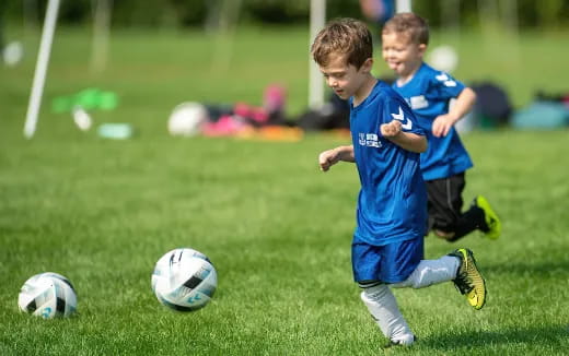 a couple of young boys playing football