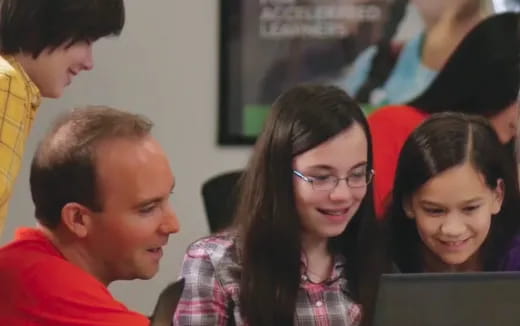 a group of people looking at a computer screen