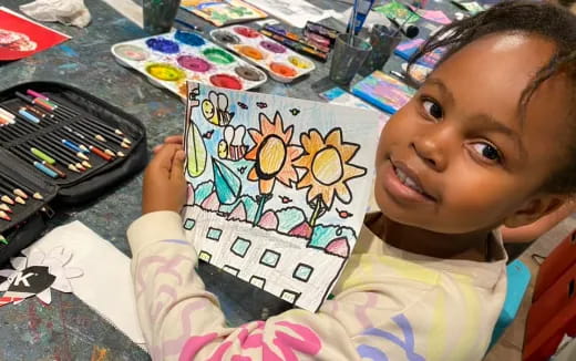 a child holding a drawing