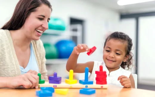 a woman and a child playing with toys