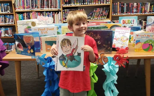 a boy holding a book