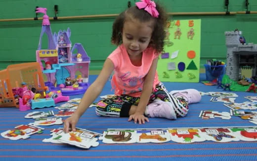 a girl playing with toys