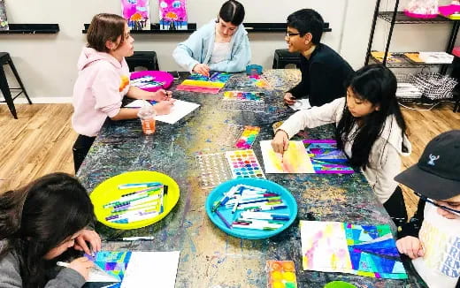 a group of people sitting around a table