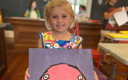 a girl holding a cake