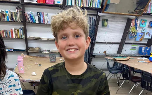 a boy smiling for the camera