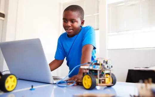 a young boy working on a laptop