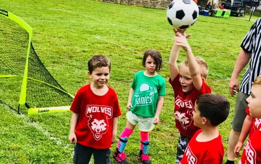a group of kids playing football
