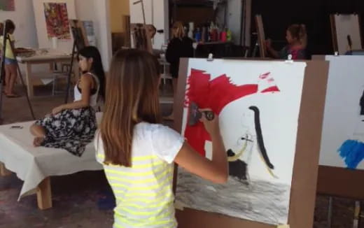 a girl painting a picture