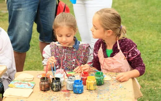 a couple of young girls painting