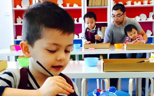 a young boy sitting at a desk