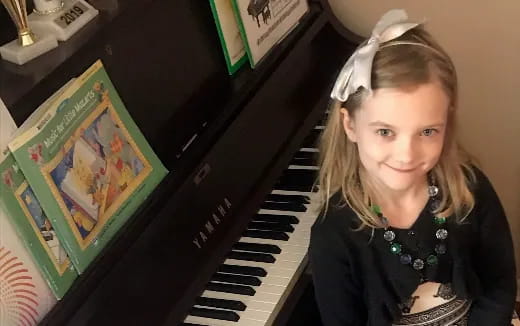 a woman with a crown and a piano