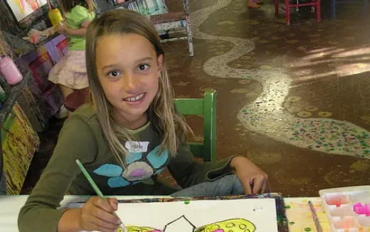 a girl sitting at a table