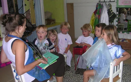 a group of children sitting in a room