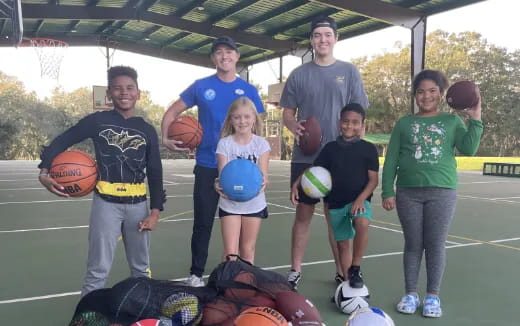 a group of people holding basketballs