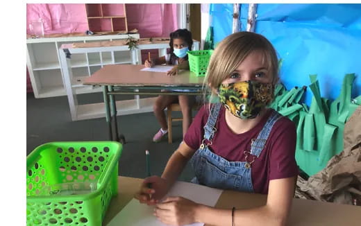 a young girl sitting on the floor