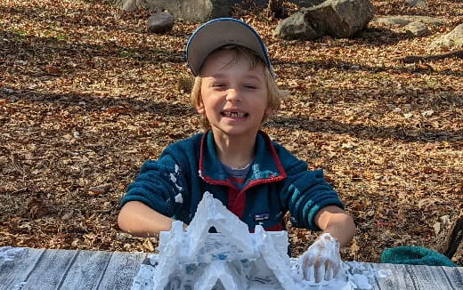 a child holding a plastic bag