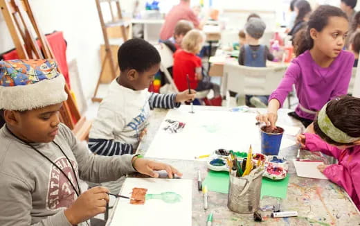 a group of children painting