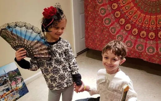 a couple of children playing with a toy