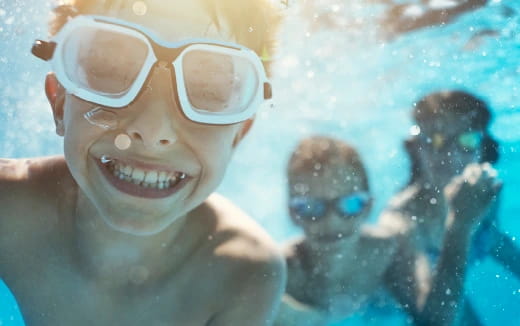 a person wearing goggles and swimming