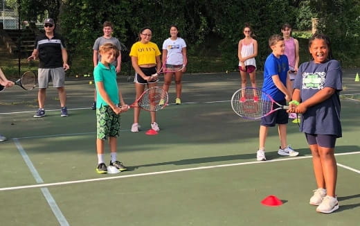 kids holding tennis rackets