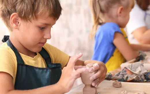a young boy playing with sand