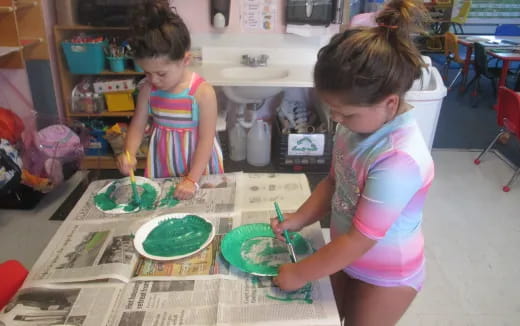 a couple of young girls painting
