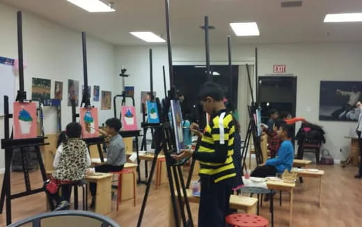 a person in a yellow vest in a room with other people