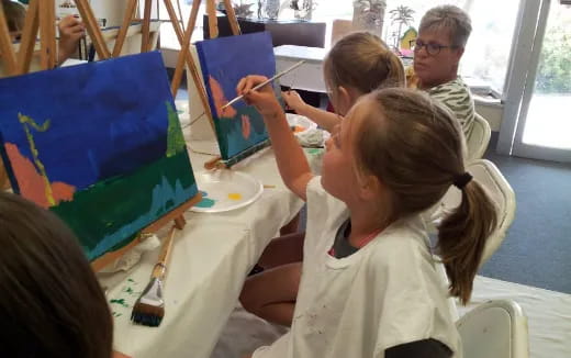 a group of children painting