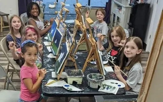 a group of children sitting at a table