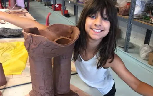 a woman holding a large brown bag