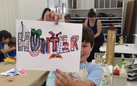 a child holding a sign