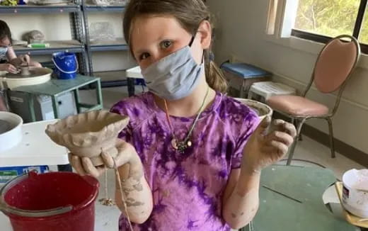 a young girl wearing a mask