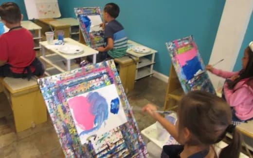 children painting on a canvas