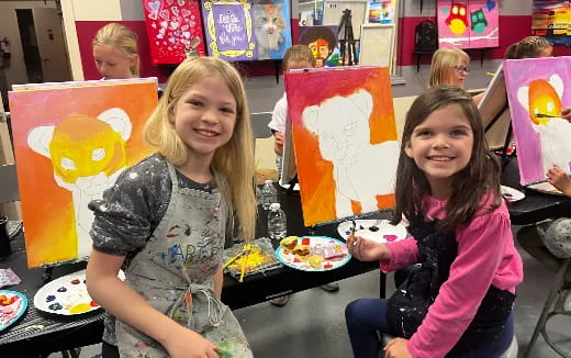 a group of girls holding up a sign