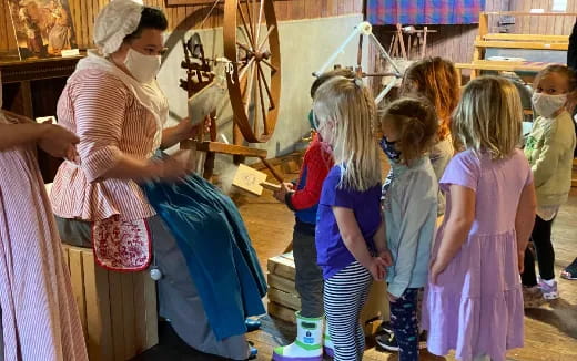 a person helping a group of children